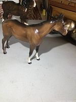 Front angle view of the Beswick horse figurine showing the glossy brown finish and white facial and leg markings.