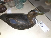Side view of decoy showing carved feather pattern and blue wing inlay