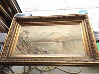 Full view of framed watercolour painting showing landscape with sailboats and mountains, signed J. Morris