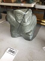 Front view of the soapstone carving figurine showing the facial details and overall shape.