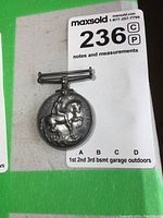 Top edge view of the medal showing suspension bar and edge inscription details.