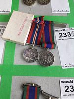 Pair of two sterling silver Canadian war medals with ribbons and original white box with red text.