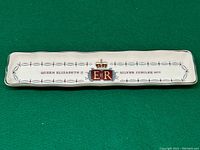 Full view of white rectangular ceramic trinket dish with crowned 'E II R' emblem and text commemorating Queen Elizabeth II Silver Jubilee 1977.