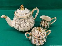 Full set of Sadler tea set on green background showing teapot, sugar bowl, and creamer