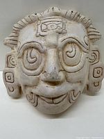 Front view of the ceramic mask showing facial details and ornamentation