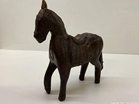 Side and front angled view of wooden horse showing full body and legs details