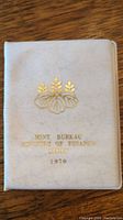White folder with gold embossed emblem and text 'Mint Bureau Ministry of Finance Japan 1970'