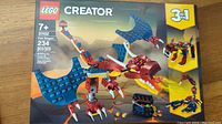 Front view of the sealed LEGO Creator 31102 Fire Dragon box showing the dragon model with wings and fire effect, indicating 234 pieces and suitability for ages 7+.