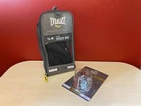 Everlast Elite Speed Bag in mesh zippered carrying bag, size Medium, with yellow zipper pull, branded with Everlast logo and size details.