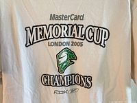 Close-up of the front graphic design displaying the MasterCard Memorial Cup London 2005 Champions text and London Knights helmet logo