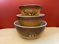 Stacked set of 3 Pyrex Old Orchard mixing bowls showing fruit pattern and size gradation