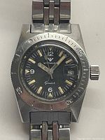 Front view showing watch face, bezel, dial details and bracelet