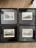Four framed handcolored engravings arranged on floor, depicting various Canadian river and town scenes, showing overall condition and framing style.