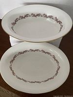 Two mint condition Minton Laurentian open vegetable bowls stacked, showing floral border and gold trim.