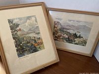Two framed watercolor paintings placed side by side against a white background showing overall condition and framing