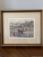 Full view of the framed artwork showing a rural scene with horses and woman by fence.