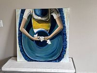 Photo of the original painting titled 'The Washer Woman' by Catalina, showing a woman washing clothes with a large blue basin.