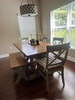 Dining room set with table, 4 chairs with cushions, and bench. Viewed diagonally from the side.