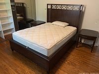 Front left angle view showing wooden bed frame with Beautyrest mattress, quilted topper and bamboo pillow