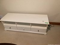 Full front angle showing the cabinet with all drawers closed and open shelves on top.