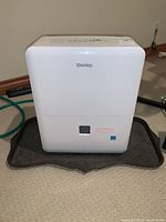 Front view of Danby white dehumidifier unit showing logo and water bucket window.