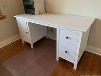 Photo from the side view showing the desk structure with a left cabinet and two right drawers.