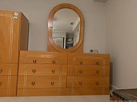 Front view of six drawer dresser with matching mirror attached in bedroom setting.