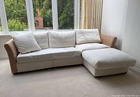 Full view of L-shaped sectional sofa placed before window