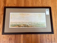 Full view of framed panoramic print of Toronto waterfront on hardwood floor