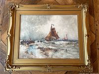 Full view of framed watercolor on parquet floor