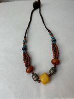 Full view of entire necklace laid flat on white background