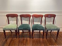 Four chairs in a row showing upholstery color variation