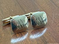 Front angled view of both cufflinks showing monogram engraving