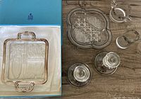 Photo showing the entire lot including the Birks square serving dish with silver overlay and silver wear, the round divided serving dish, cream and sugar set, and pair of candlesticks.