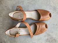 Top view of Coclico leather wedge sandal showing tan leather upper, peep-toe and ankle strap with buckle.