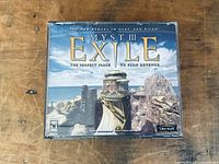Front cover of Myst III Exile DVD game case showing scenic stone and water backdrop with title.