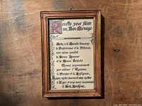 Photo of framed poem titled 'Recette Pour Faire Un Bon Ménage' with poem in French visible inside wooden frame.