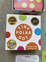 Photo of the front of the Tiny Polka Dot box showing the brand, awards, and colorful polka dot design