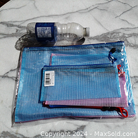 Top view showing all 6 nylon mesh zipper bags arranged largest to smallest next to a water bottle for size reference.