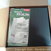 Box opened showing one of the black binders with ClearVue cover and Cardinal Speedy XtraLife branding and customization instructions.