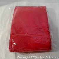 Folded red crushed velvet fabric in plastic packaging