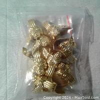 Small bag of new gold tone cabinet feet with vintage design