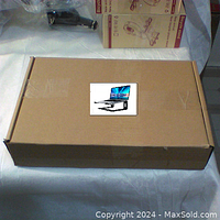 Closed box with image showing the laptop stand holding a laptop