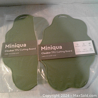 Photo of two new, sealed Miniqua Cloubior TPU cutting boards, showing the full packaging and label.
