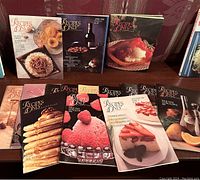 15 issues of Recipes Only magazines displayed on a table showing various food images on the covers.