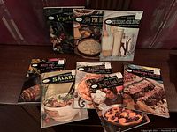 Photo of 8 Good Housekeeping mini cookbooks and 4 Homemakers books with vintage food covers