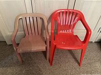 Two plastic kids chairs, one beige and one red, both with armrests, sitting on carpet.
