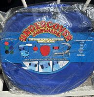 Undercover sunshade packaged in plastic with instructions visible on front.