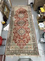 Full top-down view of the Persian Tabriz rug showing overall pattern and colors.