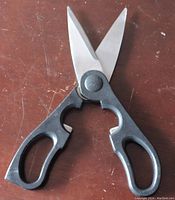 Heavy duty scissors with black handles and stainless steel blades, minor wear signs visible
